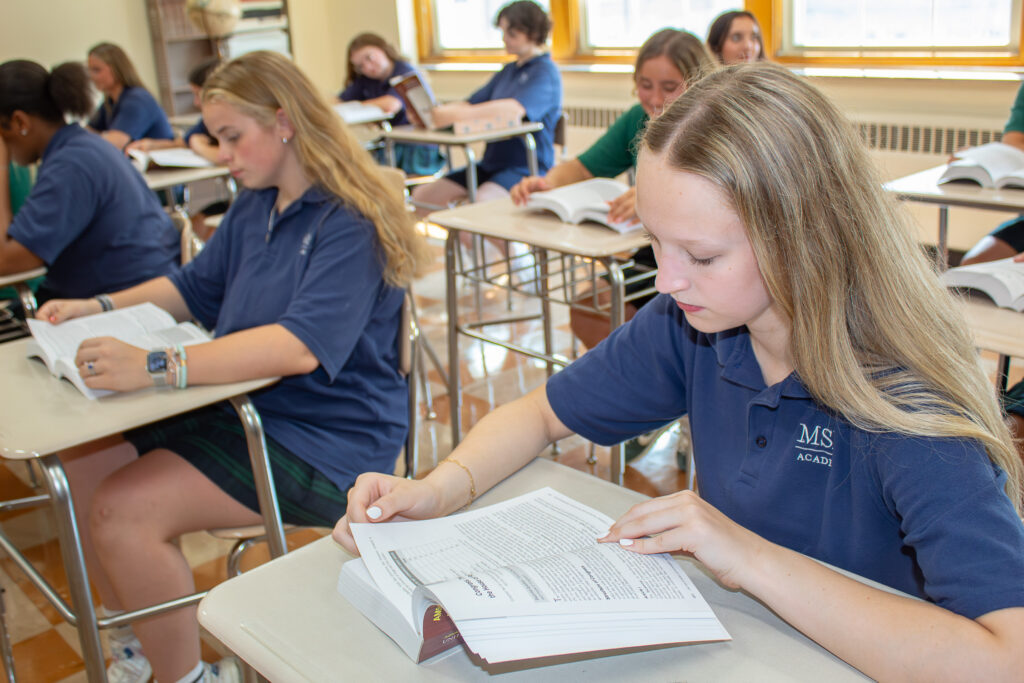 Girls in the classroom reading books at Mt St Mary Academy