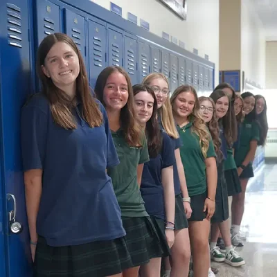 photo of girls in uniform standing in front of their lockers in the halls of MSM