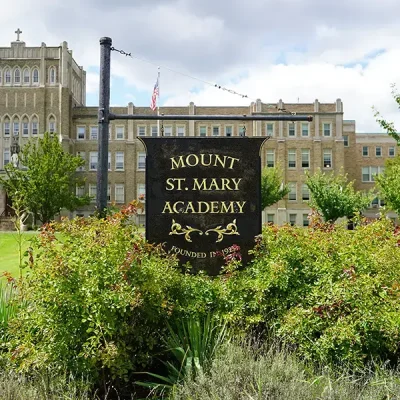 photo of the wooden sign outside of MSM with the the words Mount St. Mary Academy written on it